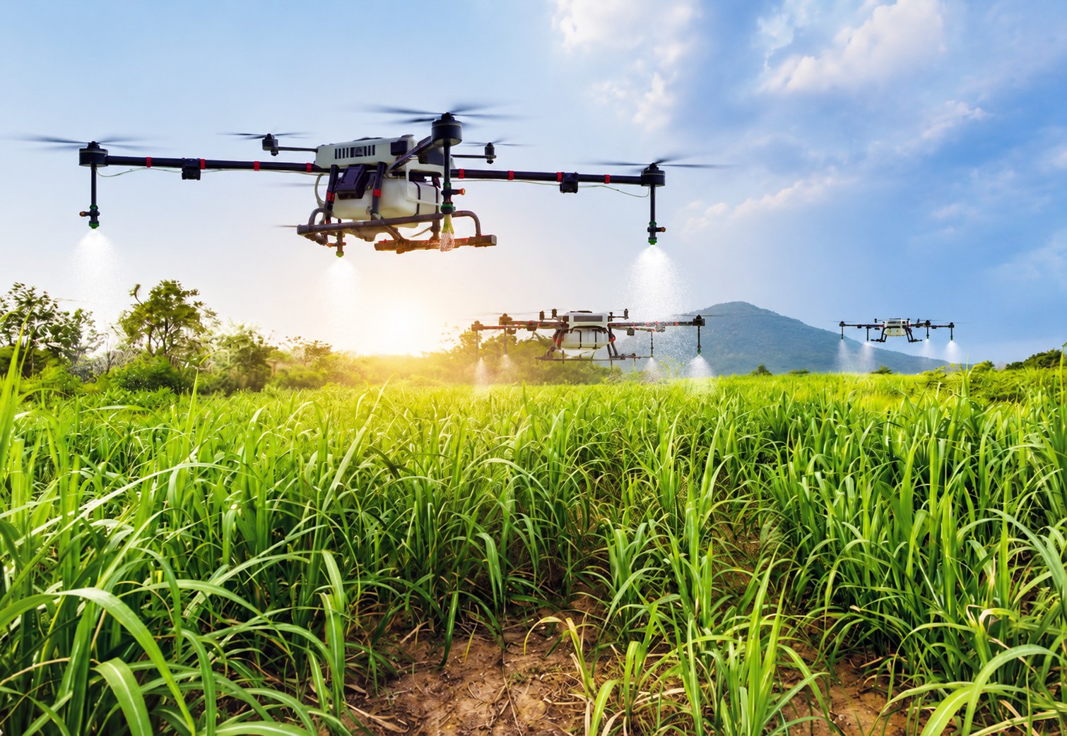 Agricultural drones applying treatments over a field